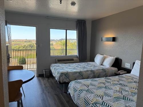 a hotel room with two beds and a balcony at Motel 6-Watsonville, CA - Monterey Area in Watsonville