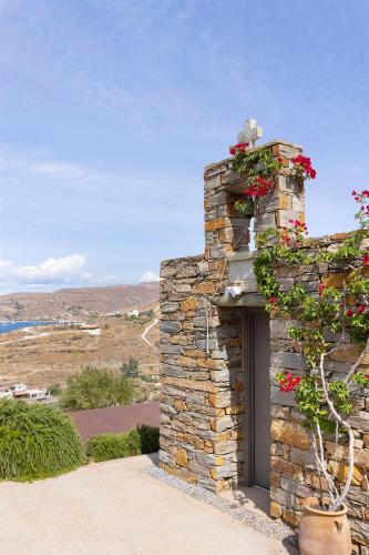 a stone fireplace with flowers on top of it at Selene in Ligia
