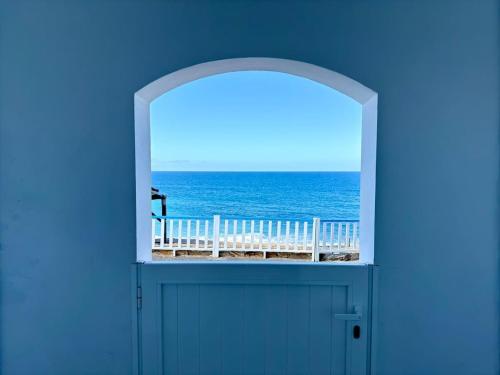 an open door with a view of the ocean at House on the beach WIFI Ajuy Fuerteventura in Ajuy