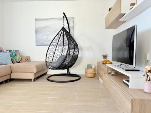 a living room with a net chair in a room at House on the beach WIFI Ajuy Fuerteventura in Ajuy