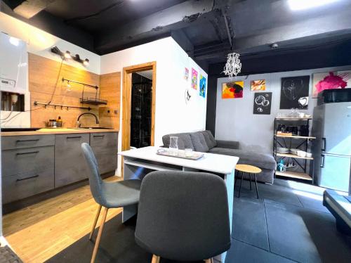 a kitchen with a couch and a table with chairs at Apartment Sport & Sauna Prague in Prague