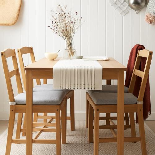 a wooden table with two chairs and a vase on it at Dalbit Thai Stay 2 Bedroom Patong house - 8mins walk to Jungcyelon Bangla Rd in Patong Beach