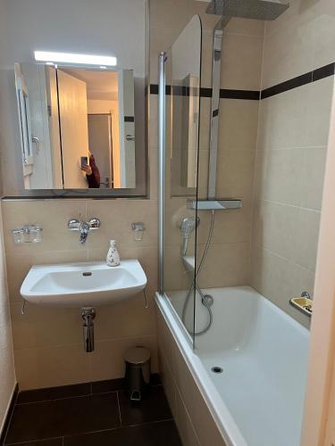 a bathroom with a sink and a shower at Sursilvana 18 (317 Ma) in Lenzerheide