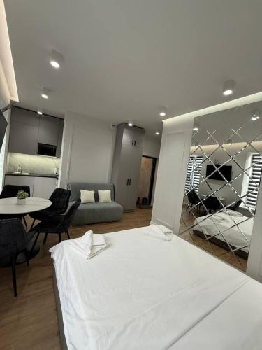 a bedroom with a bed and a table and a couch at Апартаменти на Площі Ринок 12 навпроти Ратуші після ремонту in Lviv