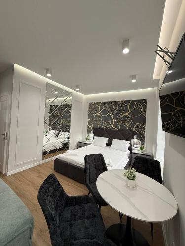 a bedroom with a bed and a table and chairs at Апартаменти на Площі Ринок 12 навпроти Ратуші після ремонту in Lviv