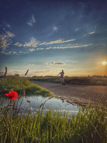 a man walking down a road with his arms out at De Meuleberg Boutique Suites 