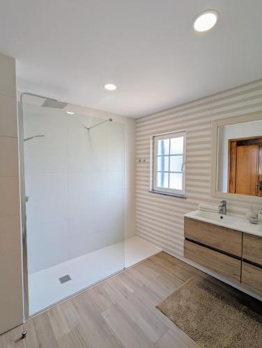 a bathroom with a shower and a sink at Casa Sousa in Lagos