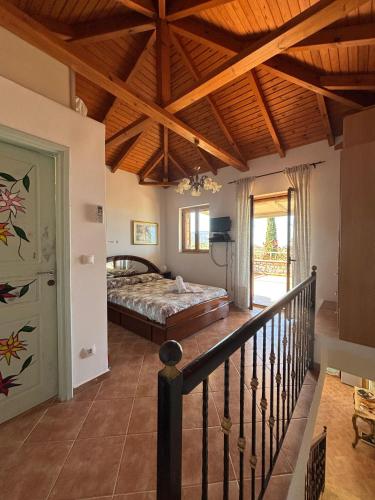 a bedroom with a bed and a wooden ceiling at Villa Panόrama in Riglia