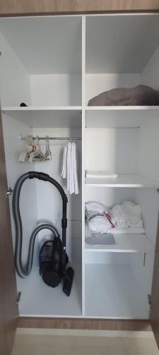 a white cabinet with a telephone in a room at S2 apartment with sea view Costa Chatt Mariam in Chott Meriem