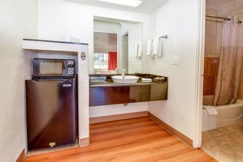 a kitchen with a sink and a refrigerator at Motel 6 Garden Grove in Anaheim