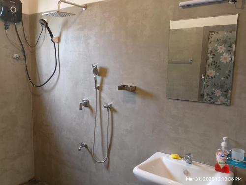 a bathroom with a shower and a sink at The Nest in Weligama
