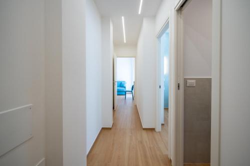 a hallway with white walls and wooden floors at Azure apartments Amalfi Coast in Maiori