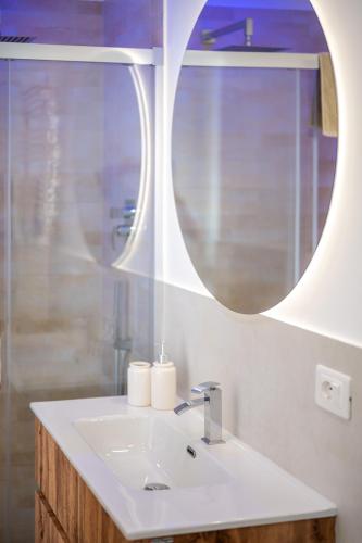 a bathroom with a sink and a mirror at Azure apartments Amalfi Coast in Maiori