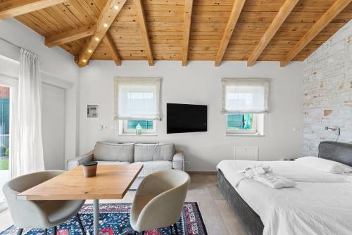 a bedroom with two beds and a table and a couch at Villa Puccini with pool and sauna in Frata