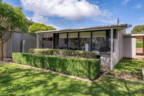 a house with green bushes in the yard at Petra Olive 3 in Yallingup