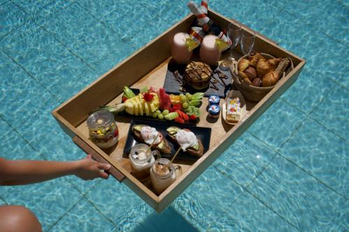an overhead view of a table of food in a boat at Peninsula Resort & Spa in Agia Pelagia