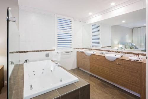 a bathroom with a tub and a sink at 'Azure' Beachside Resort Escape for Groups in Marybrook