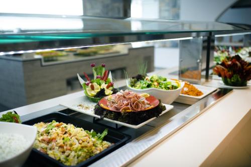 a buffet line with many different types of food at Peninsula Resort & Spa in Agia Pelagia