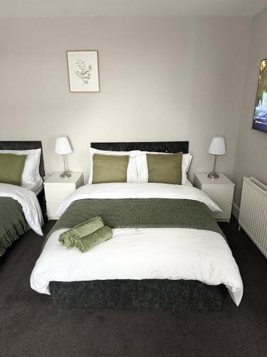 a bedroom with a large bed and two lamps at The Mill House Sleep Inn in Hartlepool