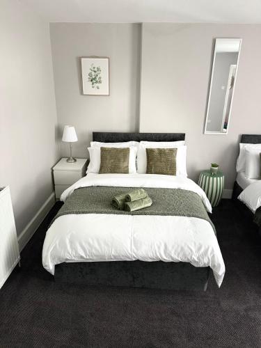 a bedroom with a large bed with a hat on it at The Mill House Sleep Inn in Hartlepool
