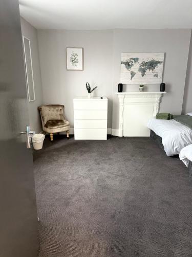 a bedroom with a bed and a white dresser at The Mill House Sleep Inn in Hartlepool