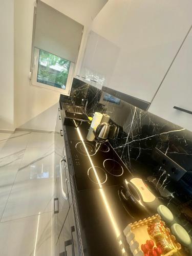 a kitchen with a sink and a counter top at Maroussi Exclussive 2 in Athens