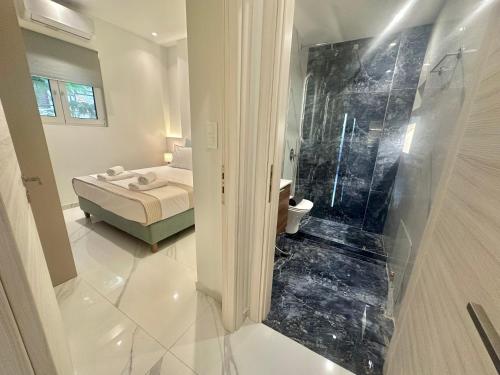 a bathroom with a bed and a walk in shower at Maroussi Exclussive 2 in Athens