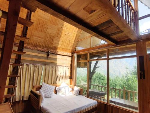 a bedroom with a bed and a large window at Applehill Stays - Work & Relax in Kulu