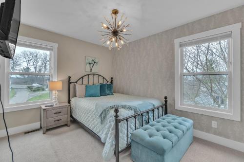 a bedroom with a bed and a chandelier at Heaven's Crown by Granger Gardens in Ann Arbor