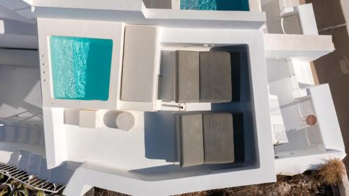 a rendering of a white building with a window at Aesthesis Boutique Villas Fira in Fira