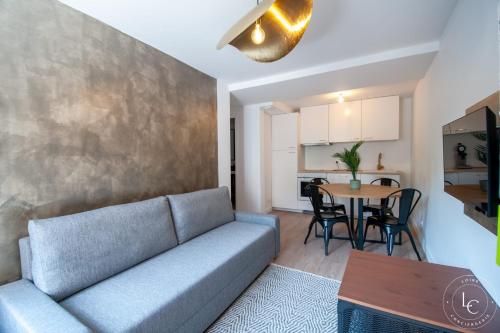 a living room with a couch and a table at Chambord Apartment Modern comfort near the Loire castles in Courbouzon