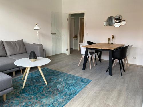 a living room with a couch and a table at discovAIXR - Super Zentral mit Parkplatz, Küche, Netflix und mehr in Eisenach
