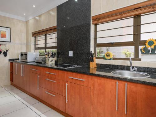 a kitchen with wooden cabinets and a sink and a window at Seagull Villa in Margate