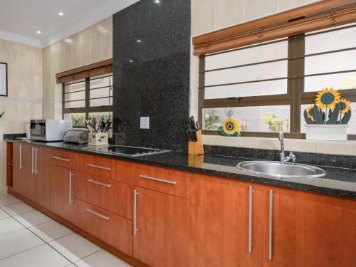 a kitchen with wooden cabinets and a sink and a window at Seagull Villa in Margate