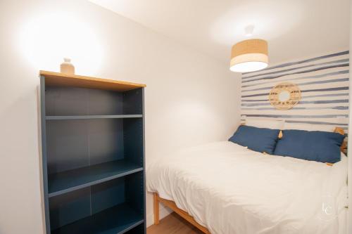 a bedroom with a bed and a book shelf at Le Cheverny Apartment Cozy stay near the Loire castles in Courbouzon