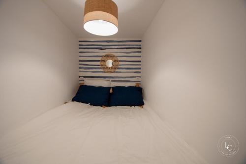 a small bedroom with a bed and a mirror at Le Cheverny Apartment Cozy stay near the Loire castles in Courbouzon