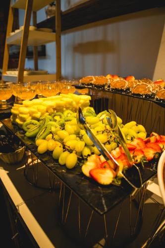 a tray of bananas and other fruit on a table at Wyndham Concepcion Pettra in Concepción