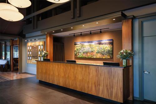 a lobby with a reception desk with a painting on the wall at Best Western Plus Hood River Inn in Hood River