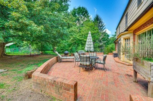 a brick patio with a table and chairs on it at 2 Mi to Main St Thomasville Family Home with Games in Thomasville