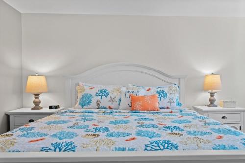 a bedroom with a bed with blue and orange pillows at Waterfront View Oasis in Cape Coral