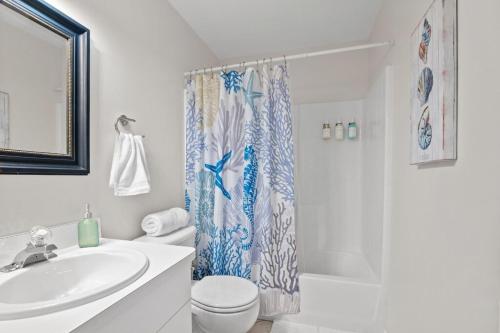 a bathroom with a sink and a toilet and a shower at Waterfront View Oasis in Cape Coral