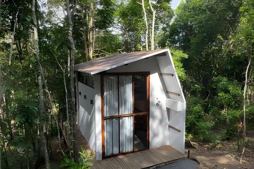 a tiny house in the woods with a door at Itacaré Ecolodge in Itacaré