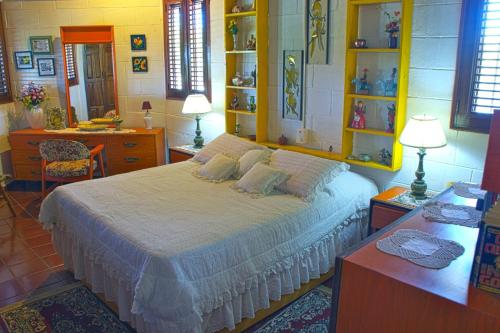 a bedroom with a bed and a table and a desk at Hillhouse in Río San Juan