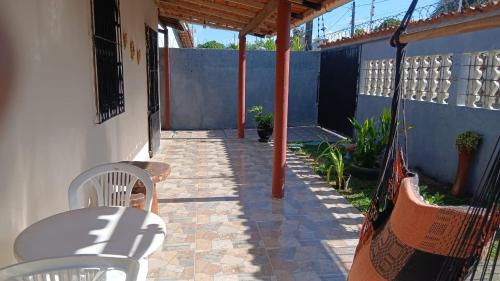 a patio with a table and chairs on a house at casa em salinopolis in Salinópolis
