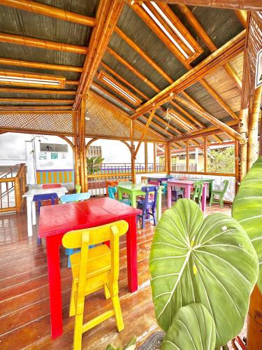 a brightly colored table and chairs in a restaurant at Eco Hotel las Palmas in Armenia