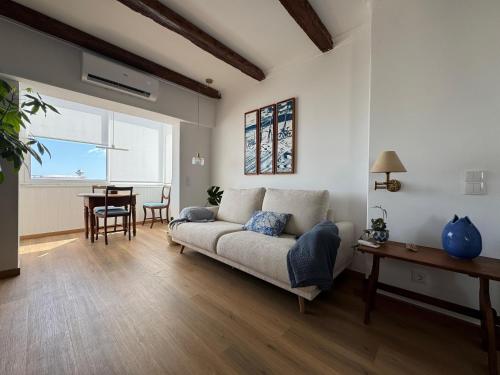a living room with a couch and a table at WHome Seaside Getaway Beachfront Apartment in Estoril