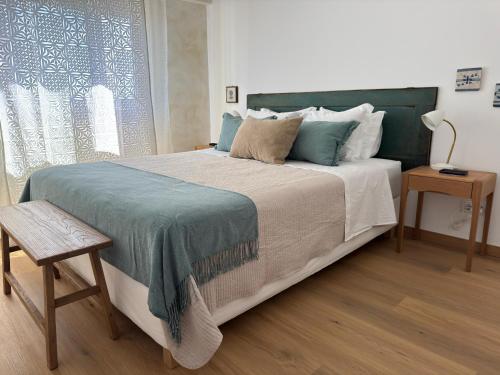 a bedroom with a large bed and a window at WHome Seaside Getaway Beachfront Apartment in Estoril