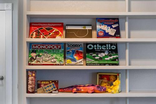 a book shelf filled with lots of games and toys at Modern 3BR Mountain Escape | FirePit • Workstation in Suffern