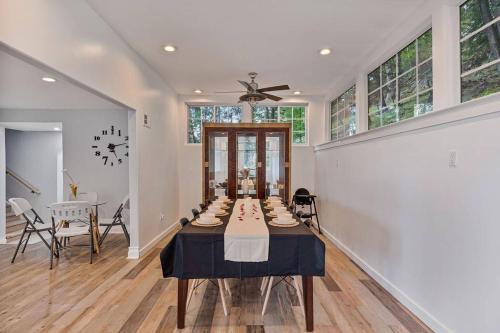 a large dining room with a table and a clock at Modern 3BR Mountain Escape | FirePit • Workstation in Suffern