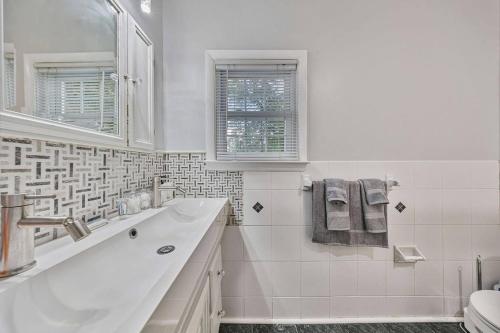 a white bathroom with a tub and a sink at Modern 3BR Mountain Escape | FirePit • Workstation in Suffern